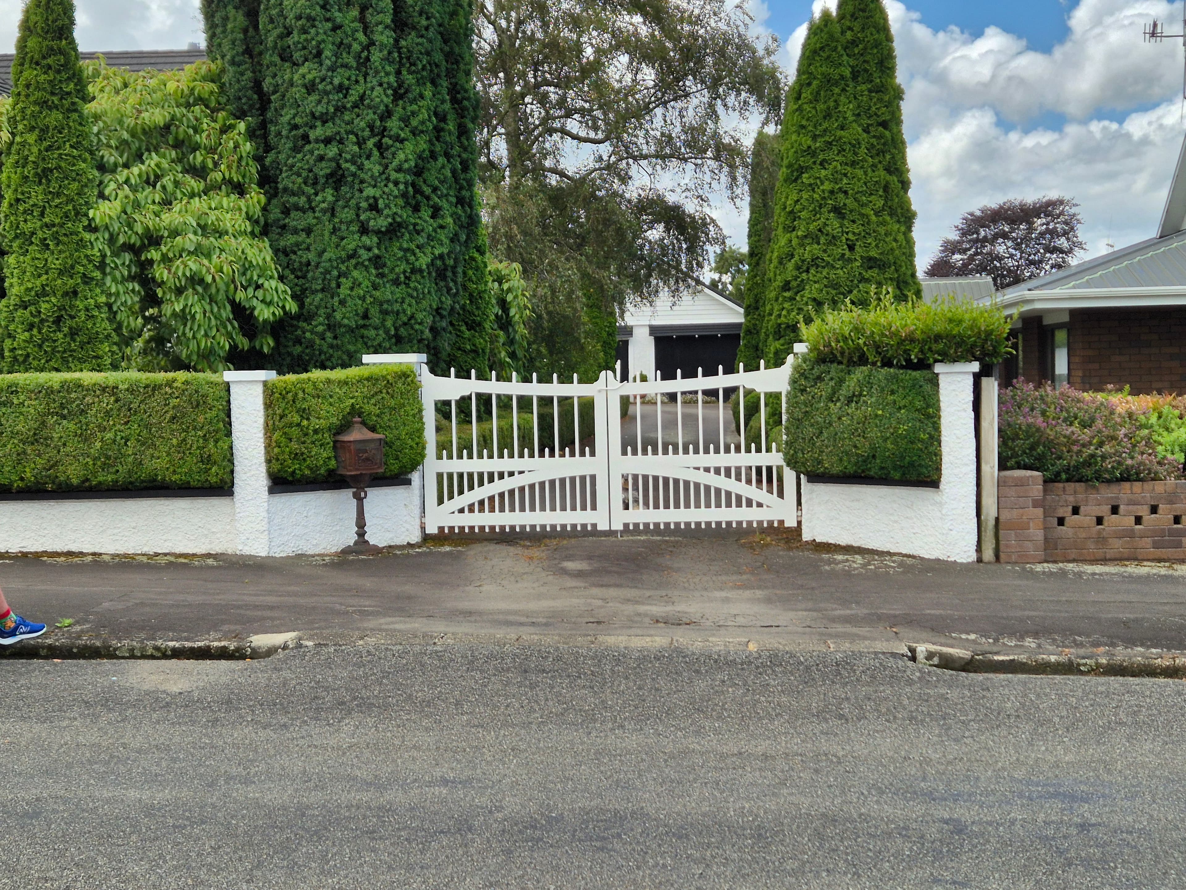 Estate entrance gate flanked by pillars